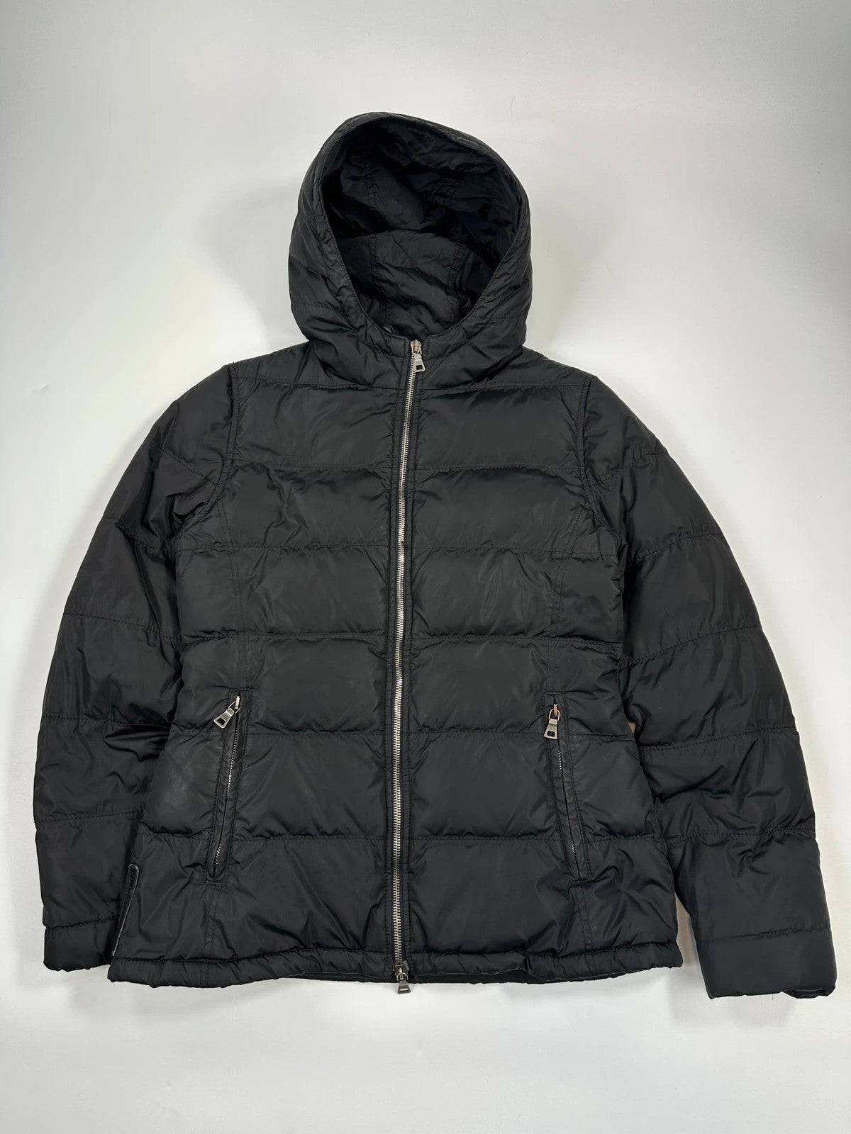 Prada black fitted nylon down puffer jacket with hood and logo detail.