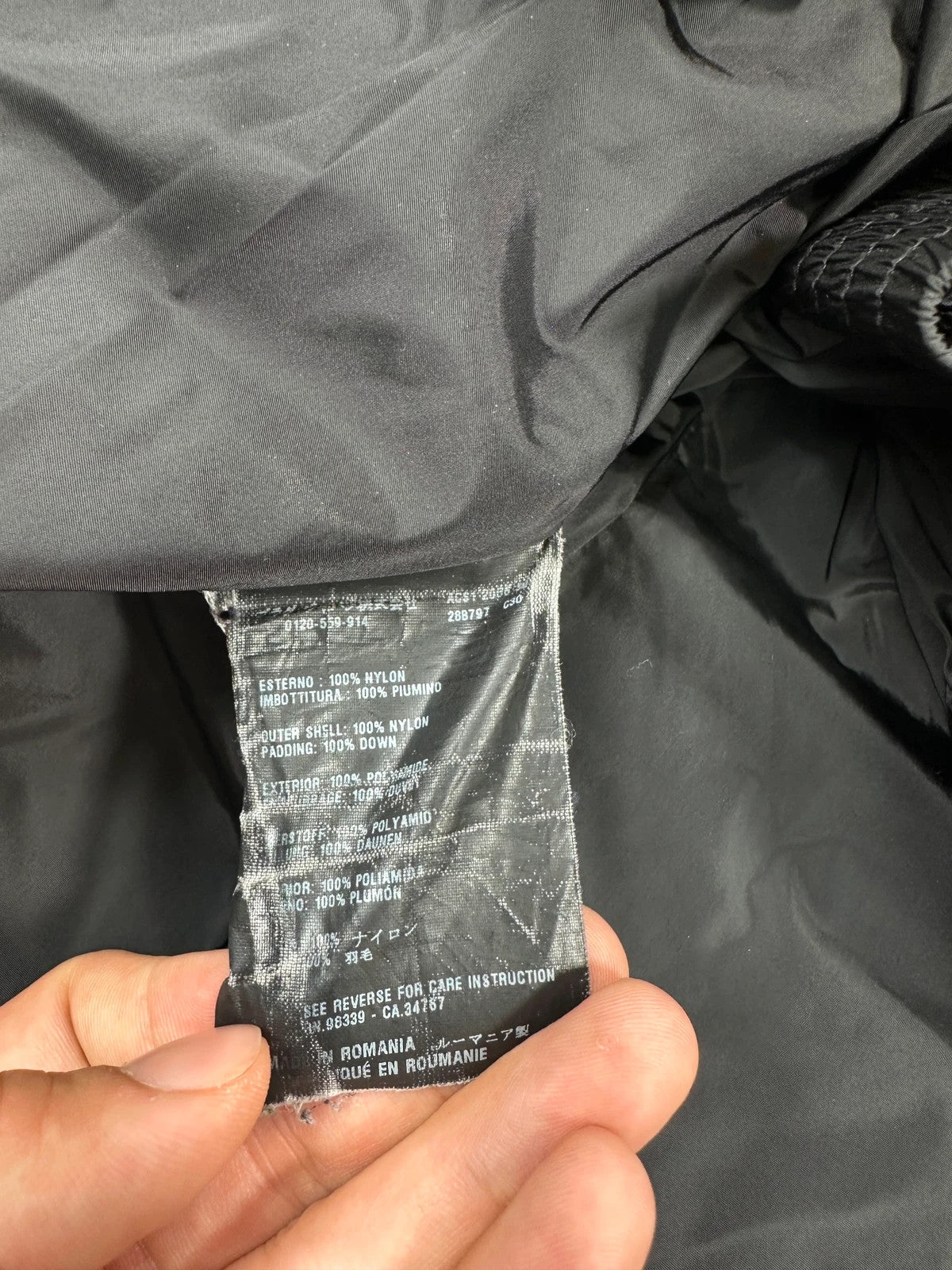 Prada black fitted nylon down puffer jacket with hood and logo detail.