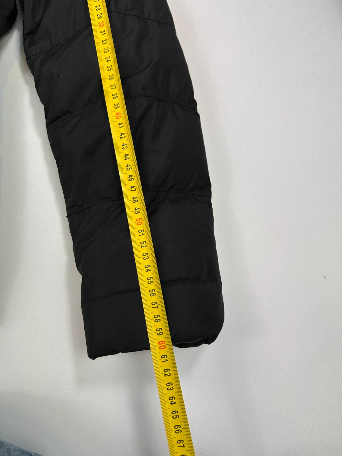 Prada black fitted nylon down puffer jacket with hood and logo detail.
