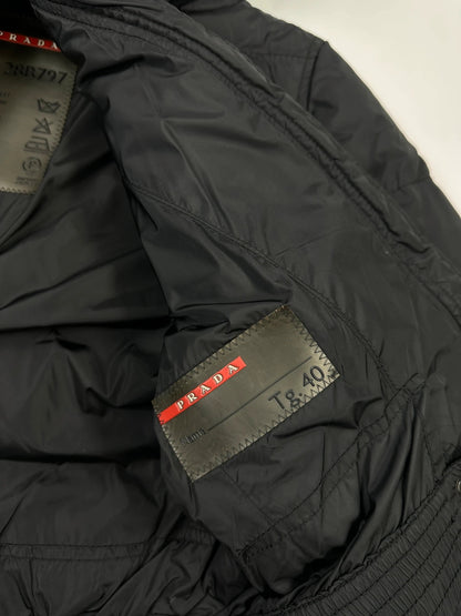 Prada black fitted nylon down puffer jacket with hood and logo detail.