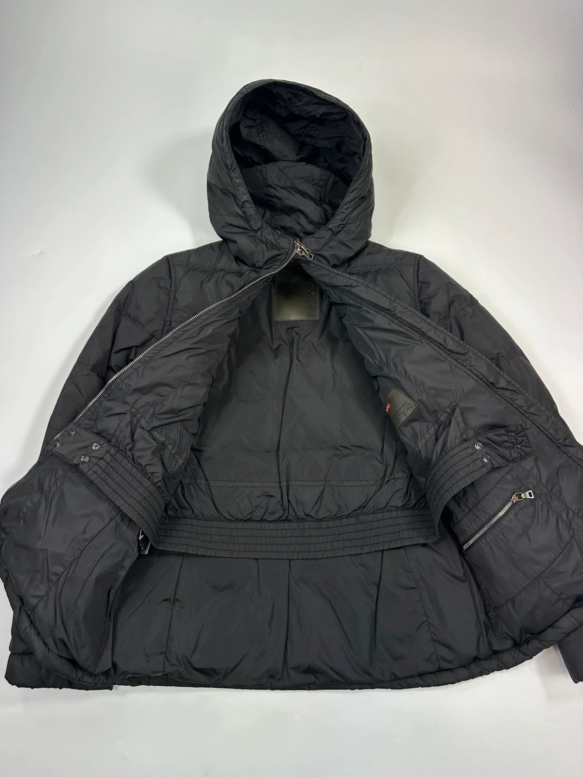 Prada black fitted nylon down puffer jacket with hood and logo detail.