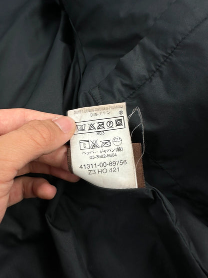 Moncler black hooded puffer jacket with logo patch and quilted down detailing.
