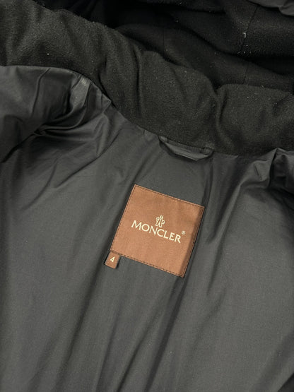 Moncler black hooded puffer jacket with logo patch and quilted down detailing.