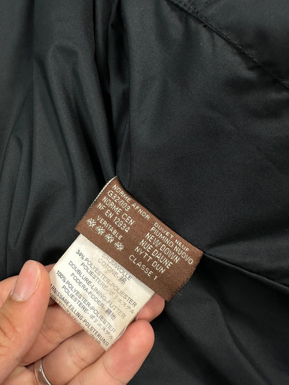 Moncler black hooded puffer jacket with logo patch and quilted down detailing.
