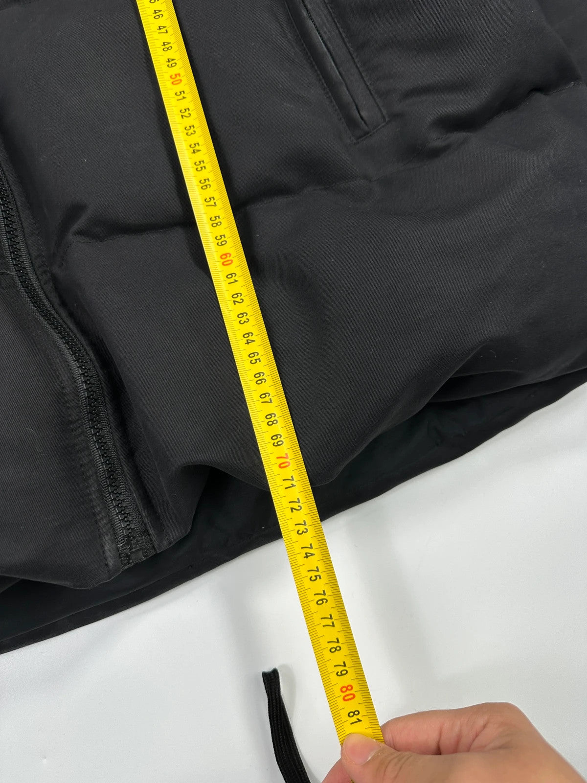 Moncler black hooded puffer jacket with logo patch and quilted down detailing.