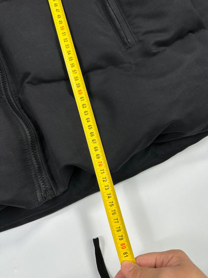 Moncler black hooded puffer jacket with logo patch and quilted down detailing.