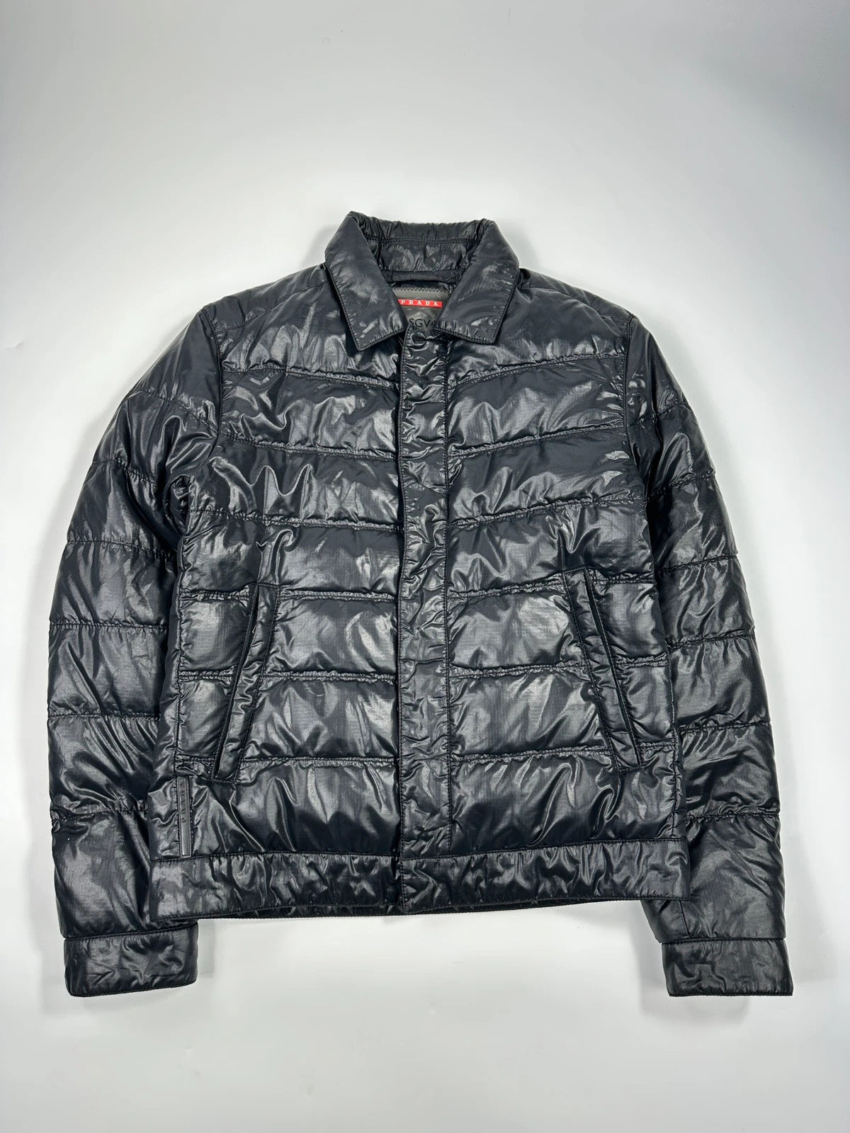 Prada black puffer jacket with shirt collar and Ripstop nylon fabric.