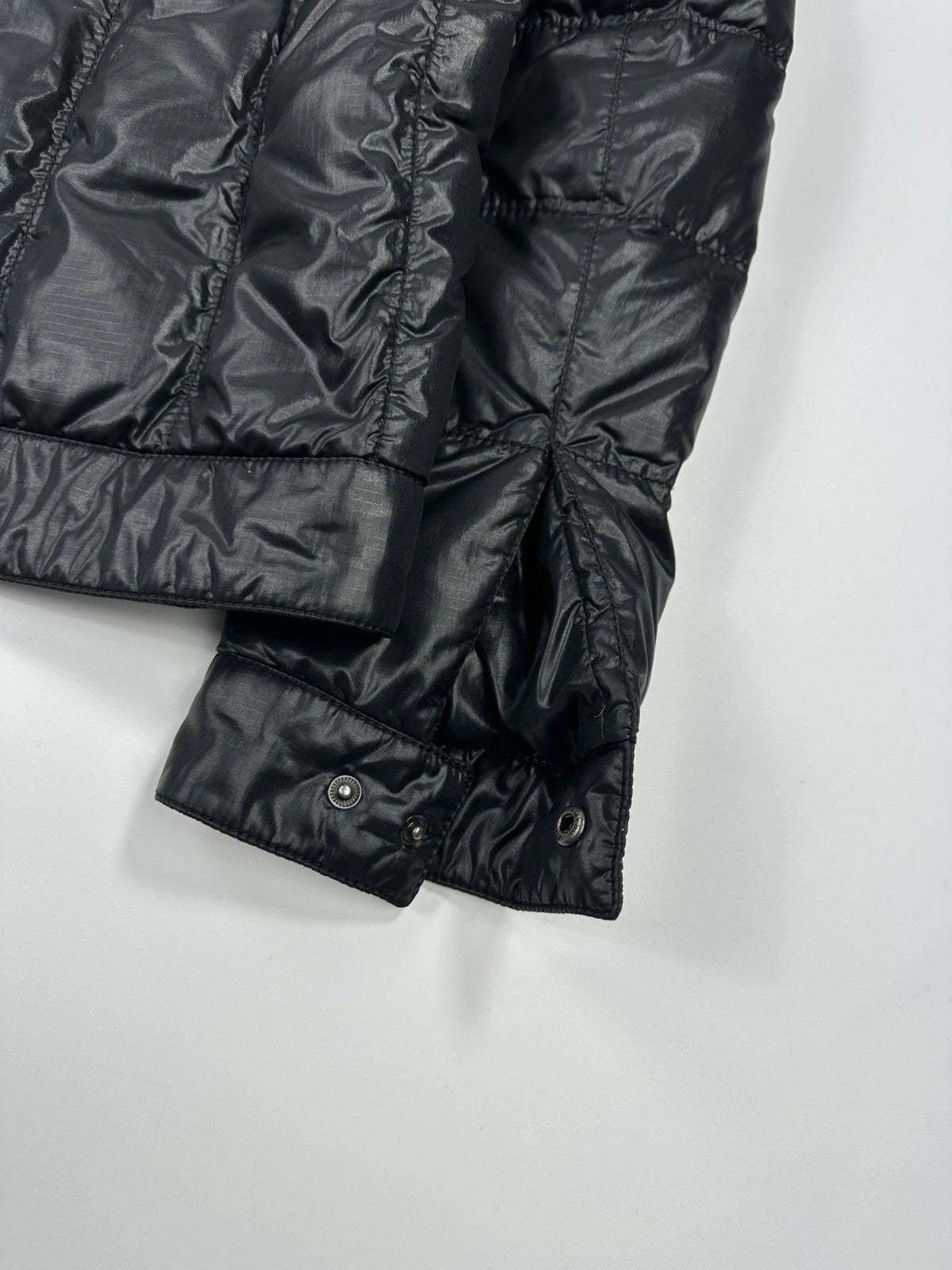 Prada black puffer jacket with shirt collar and Ripstop nylon fabric.