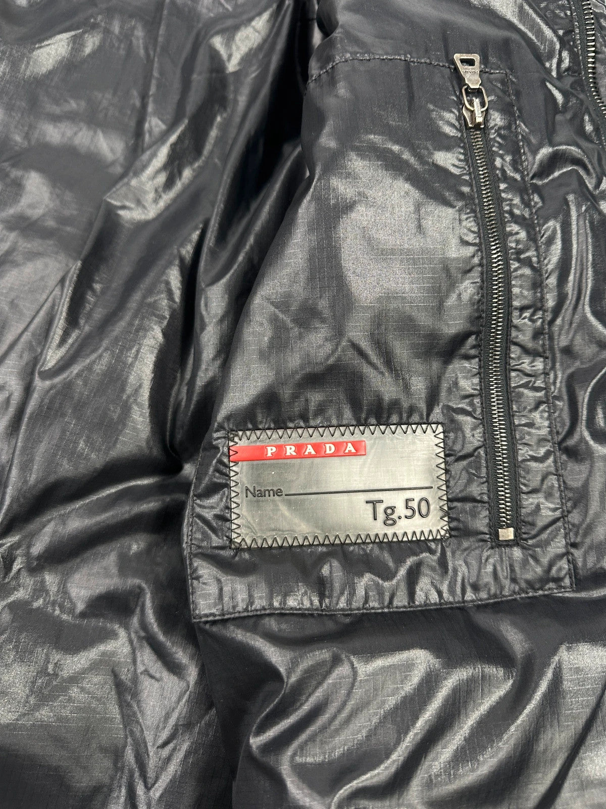 Prada black puffer jacket with shirt collar and Ripstop nylon fabric.