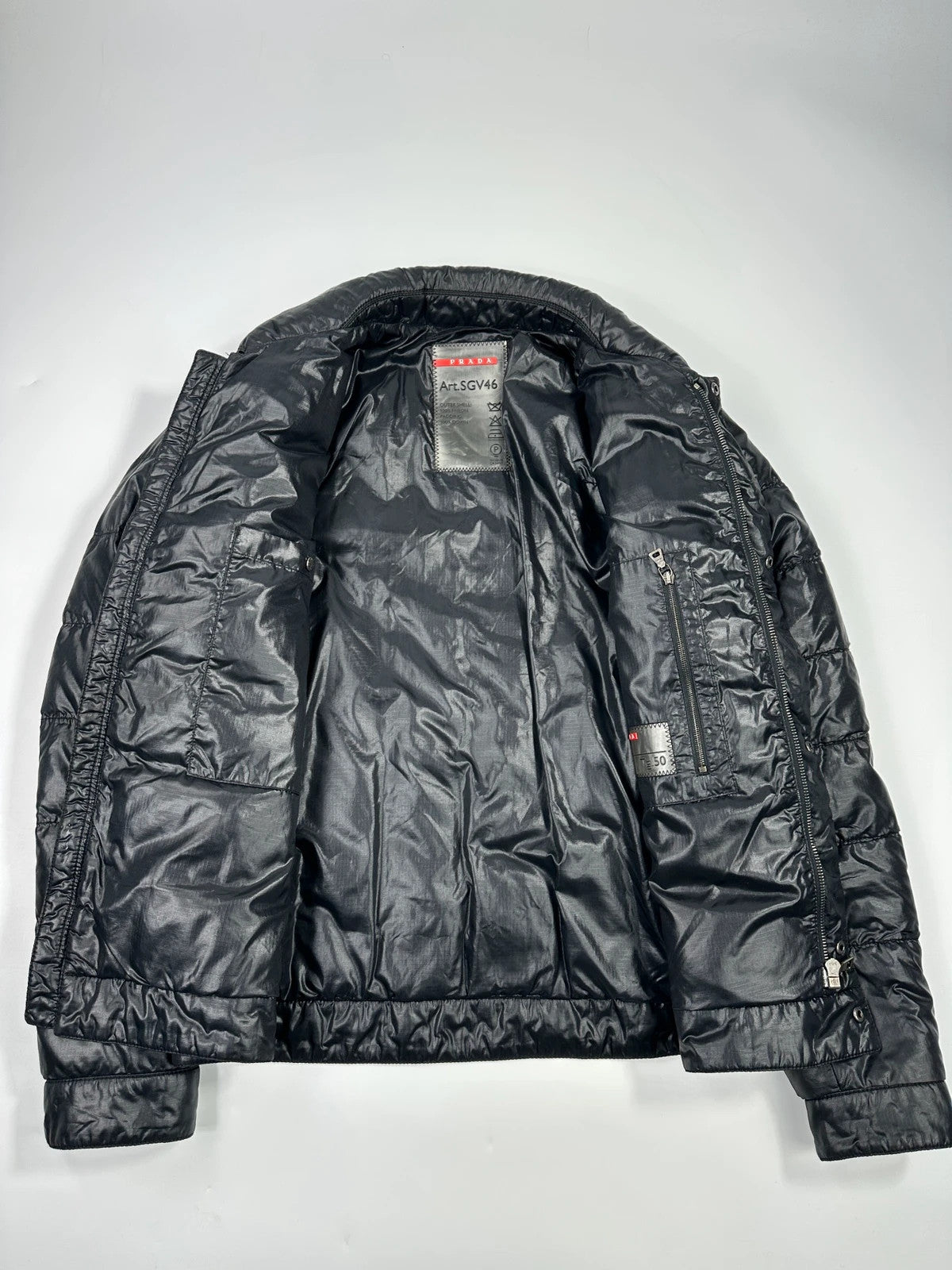 Prada black puffer jacket with shirt collar and Ripstop nylon fabric.