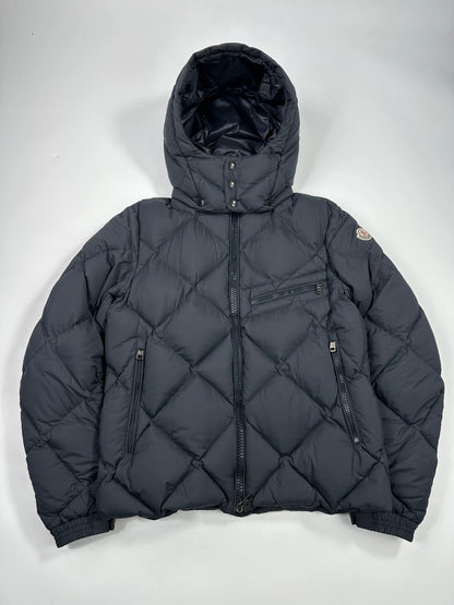 Moncler navy blue puffer jacket with diamond pattern, hood, and down filling.