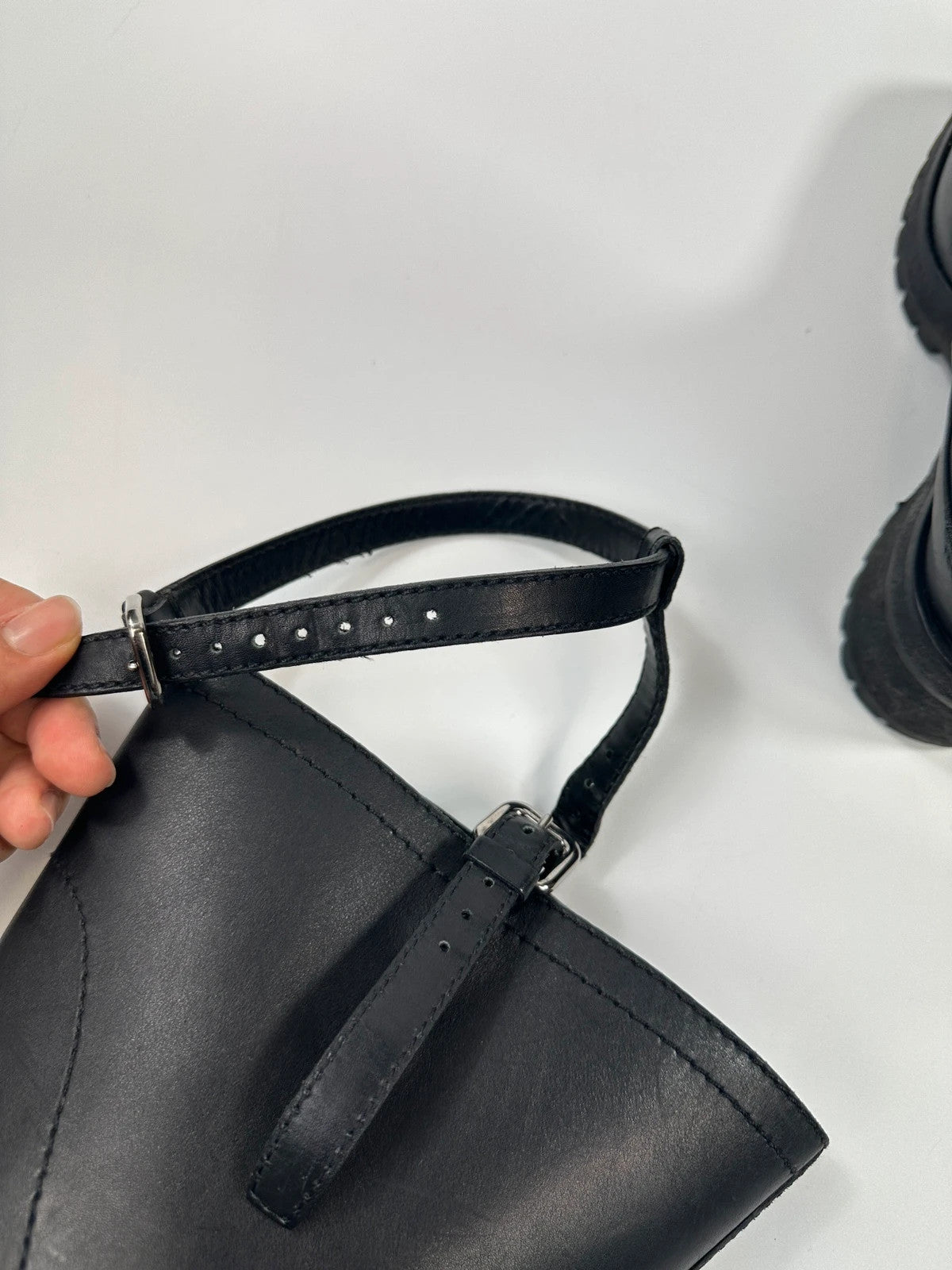 Prada black leather garter strap boots with minimalist design and original box.