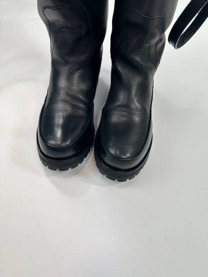 Prada black leather garter strap boots with minimalist design and original box.