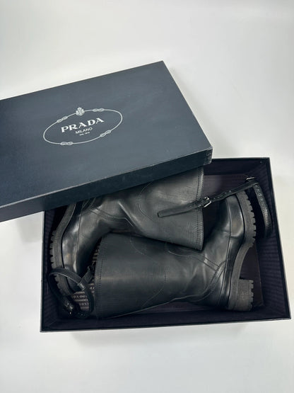 Prada black leather garter strap boots with minimalist design and original box.