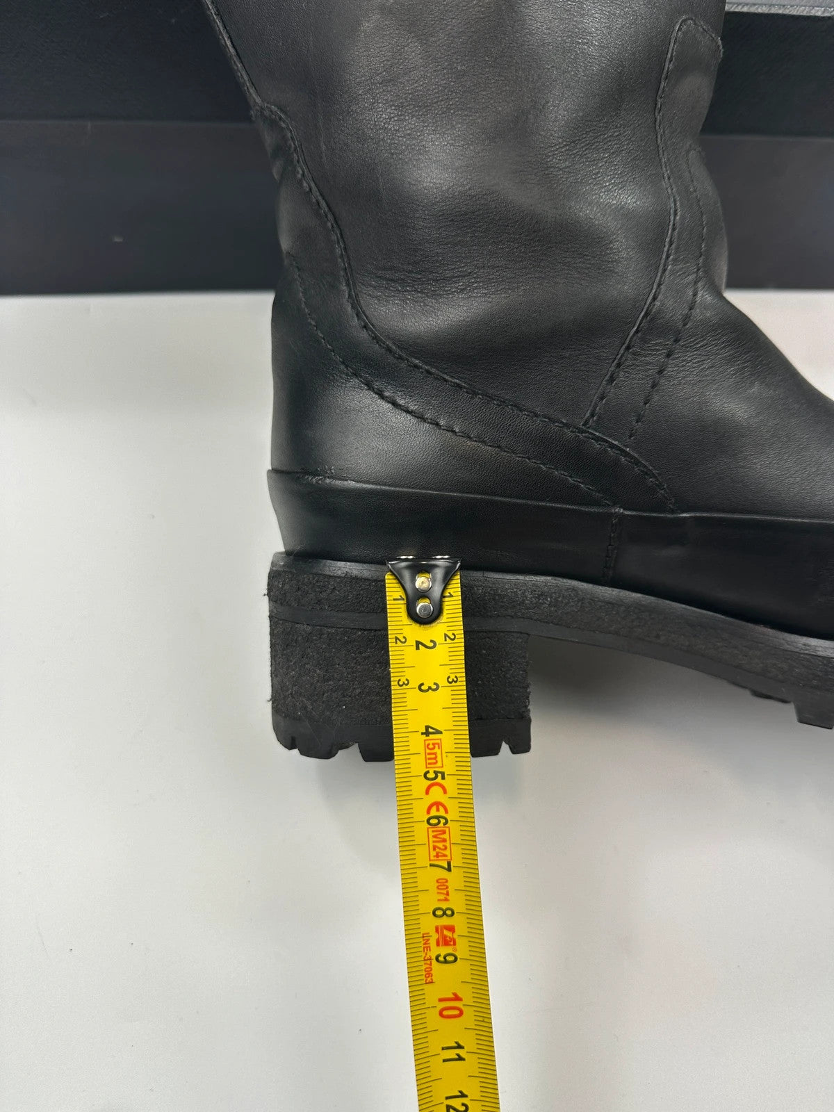 Prada black leather garter strap boots with minimalist design and original box.