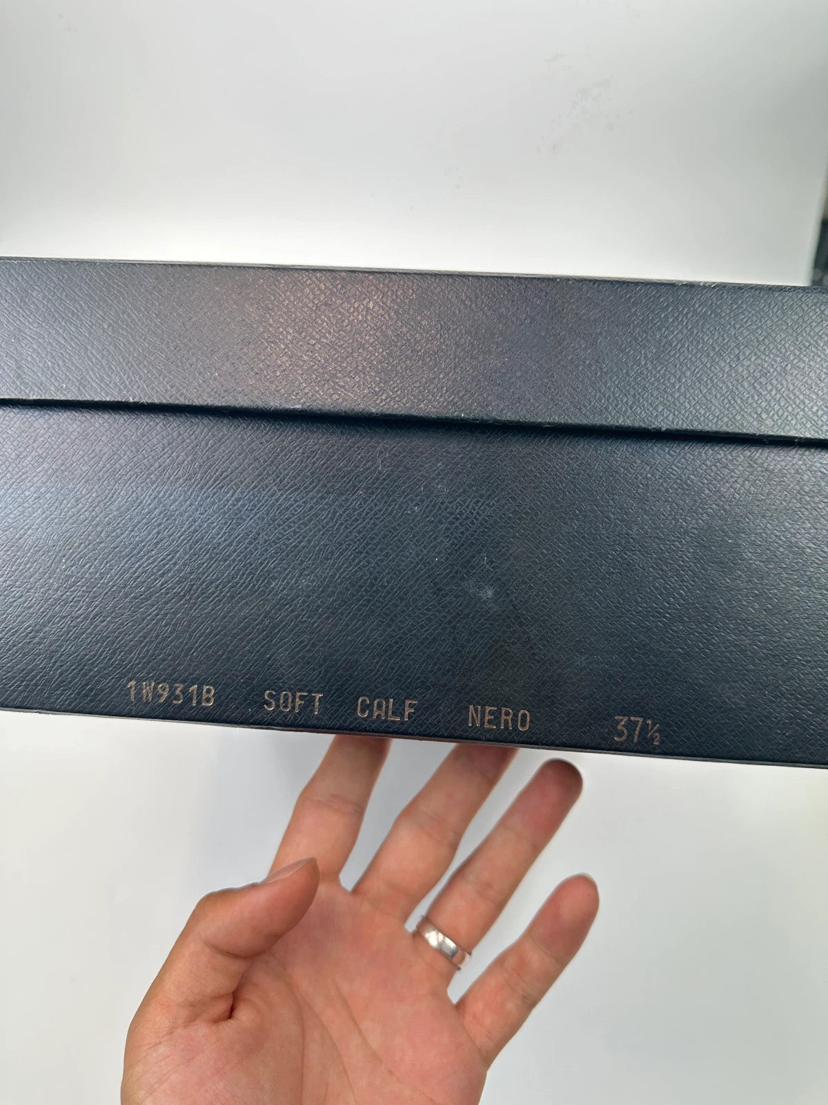 Prada black leather garter strap boots with minimalist design and original box.