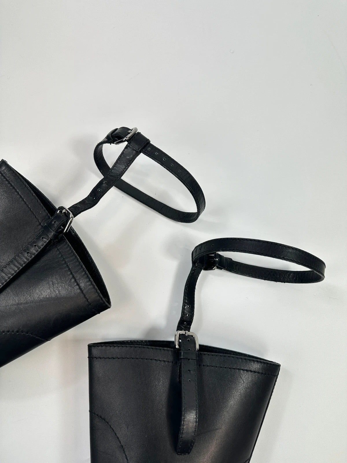 Prada black leather garter strap boots with minimalist design and original box.