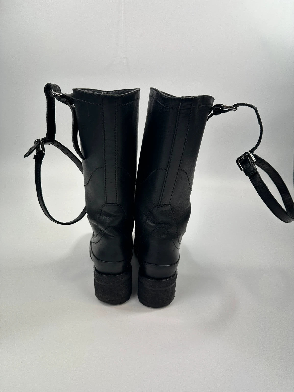 Prada black leather garter strap boots with minimalist design and original box.