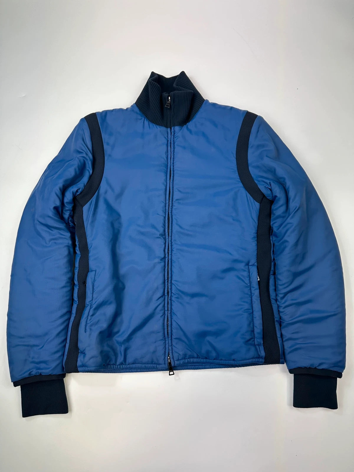 Prada blue padded nylon tech jacket with logo detail and minimalist design.