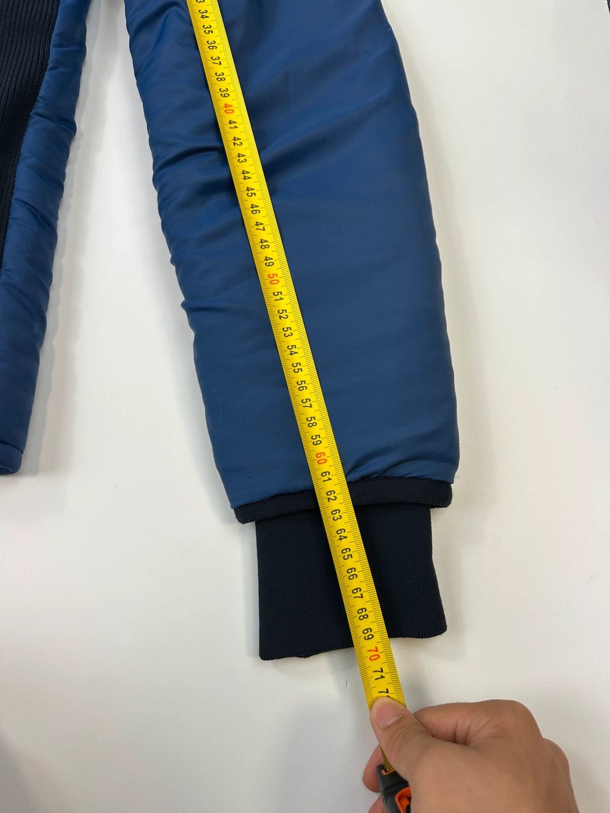 Prada blue padded nylon tech jacket with logo detail and minimalist design.