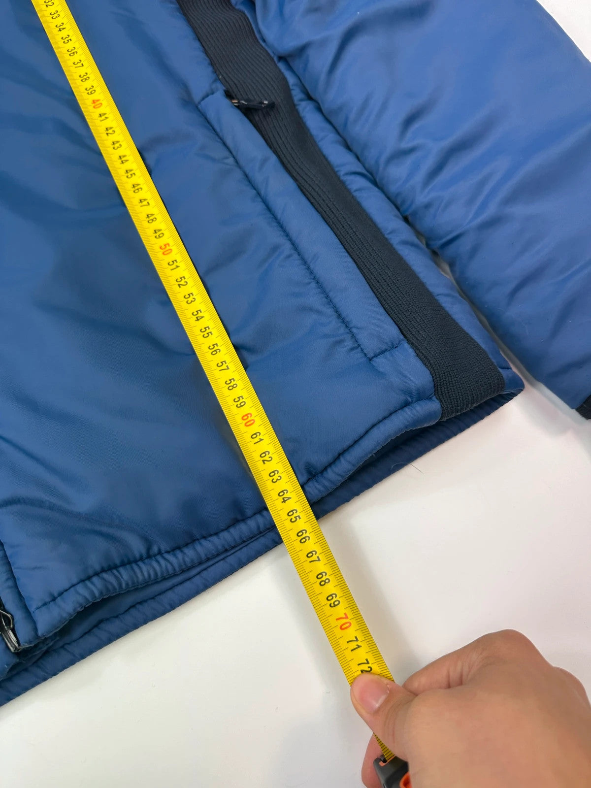 Prada blue padded nylon tech jacket with logo detail and minimalist design.