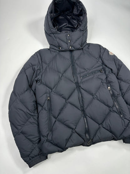 Moncler navy blue puffer jacket with diamond pattern, hood, and down filling.