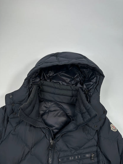 Moncler navy blue puffer jacket with diamond pattern, hood, and down filling.