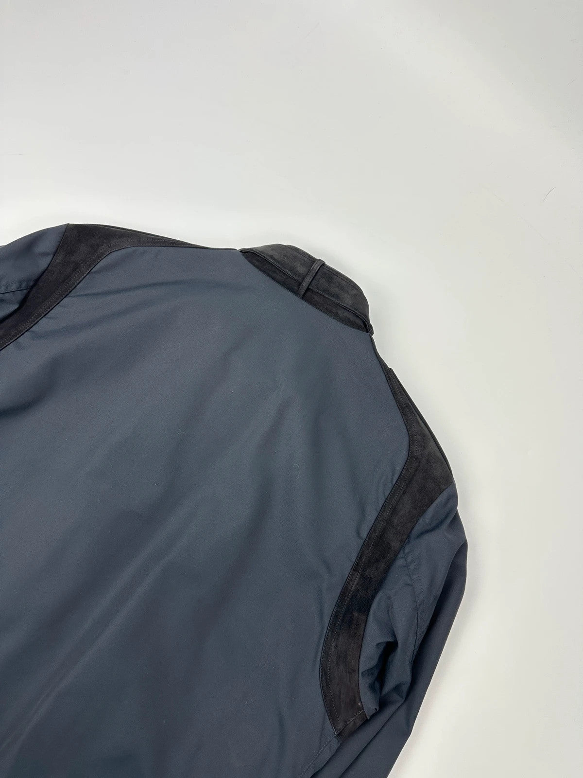 Gucci navy blue bomber jacket with suede inserts and vintage 2000s design.