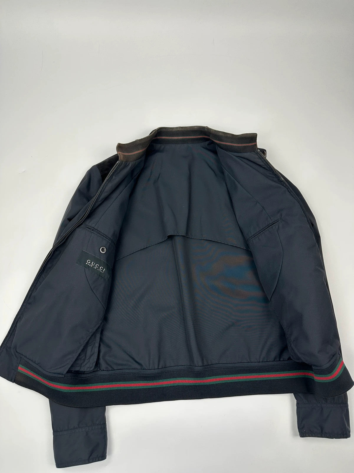 Gucci navy blue bomber jacket with suede inserts and vintage 2000s design.