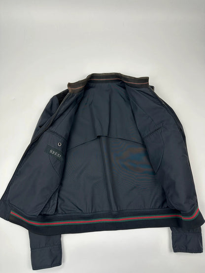 Gucci navy blue bomber jacket with suede inserts and vintage 2000s design.