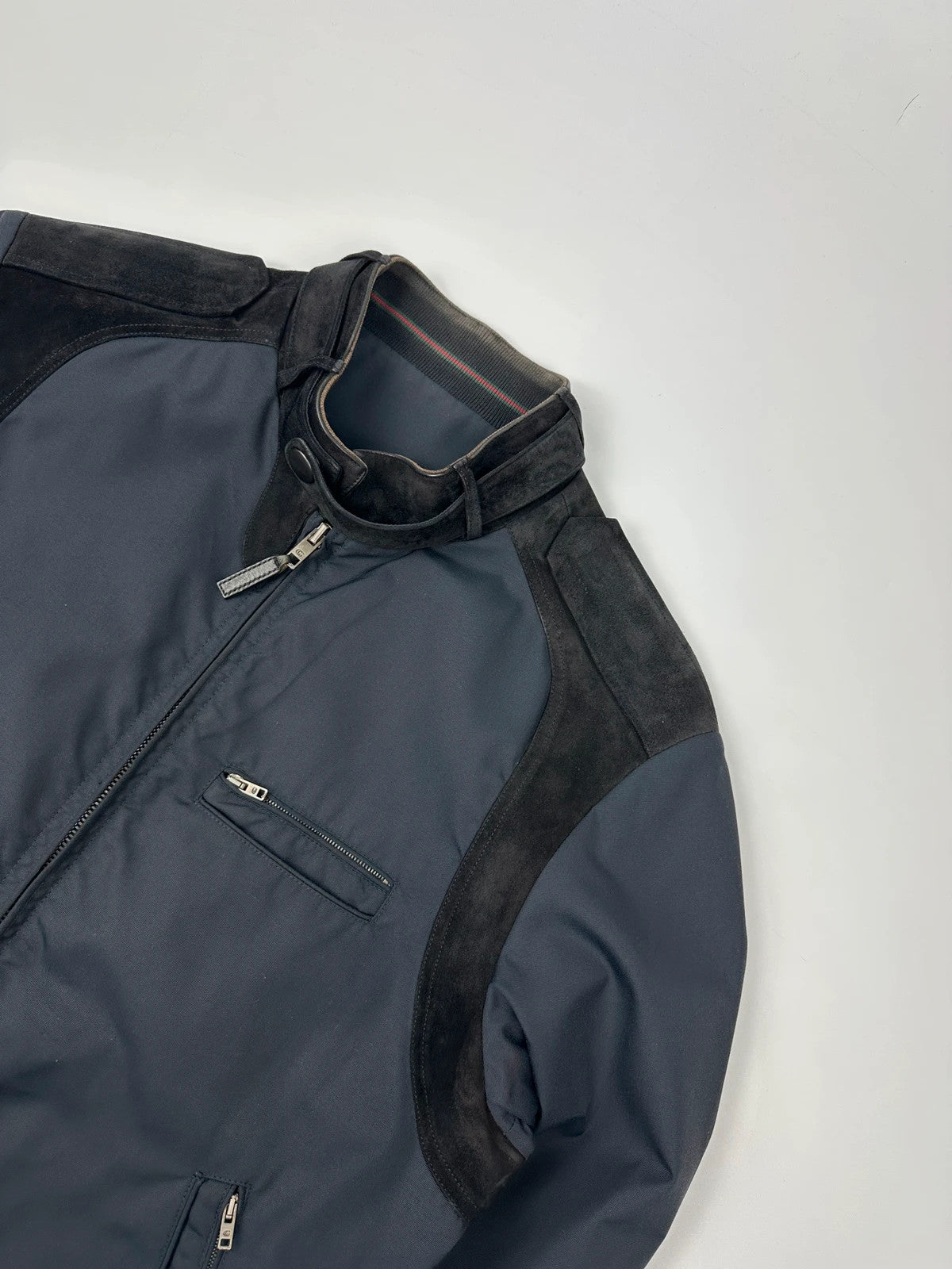 Gucci navy blue bomber jacket with suede inserts and vintage 2000s design.