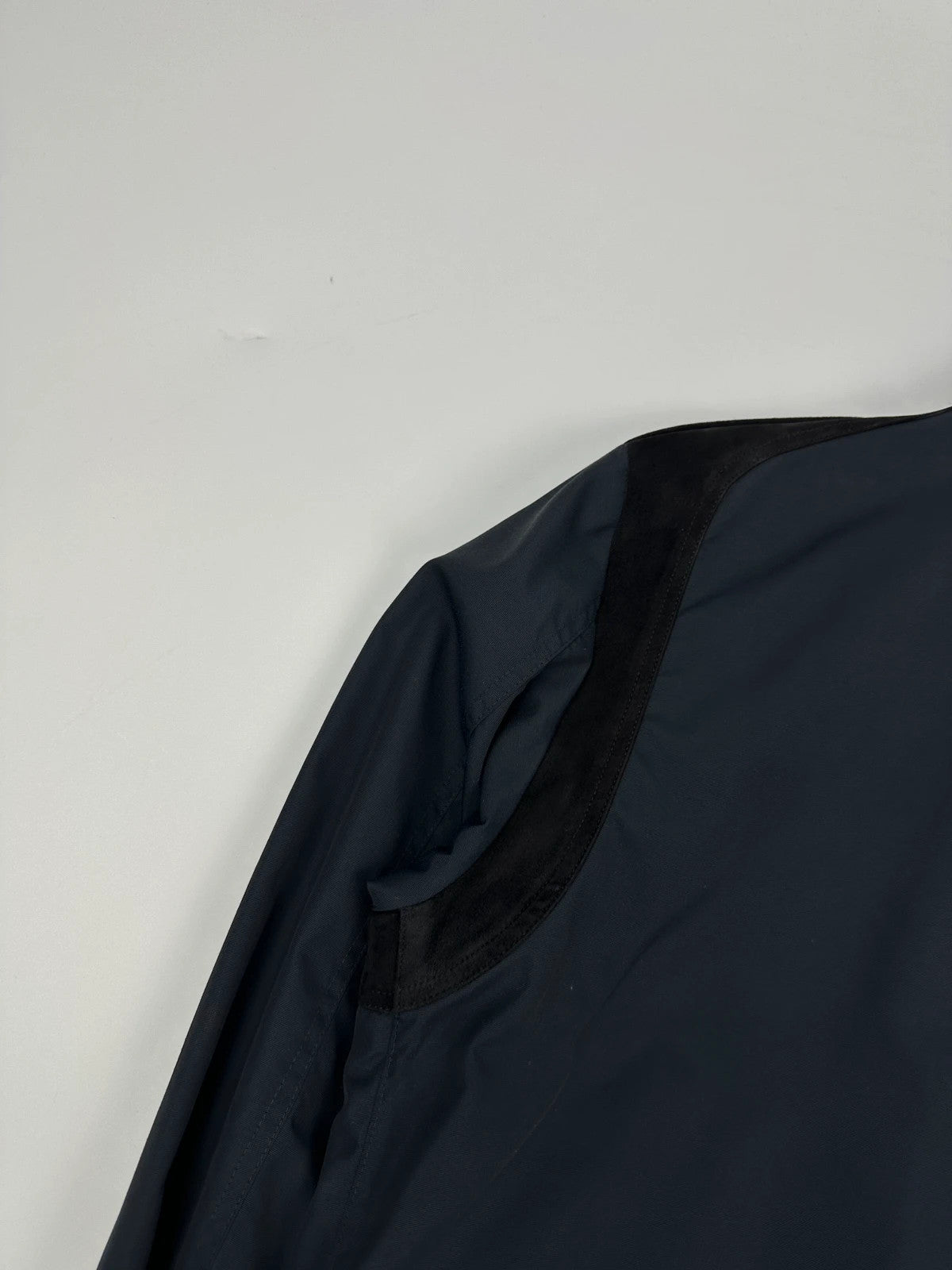 Gucci navy blue bomber jacket with suede inserts and vintage 2000s design.