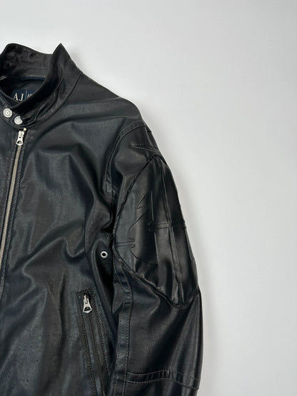 Armani Jeans black faux leather jacket with worn pockets and minimalist design.