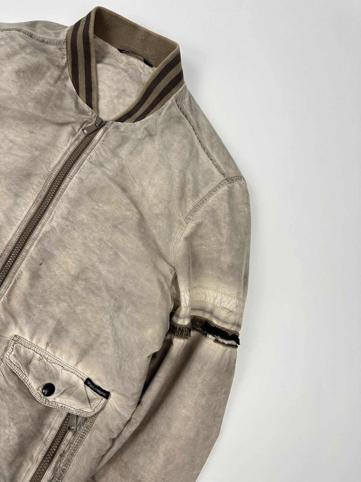 Dolce & Gabbana beige grey bomber jacket with faded nylon and logo details.
