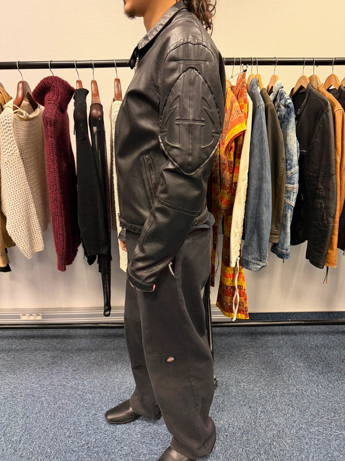 Armani Jeans black faux leather jacket with worn pockets and minimalist design.