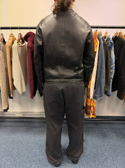 Armani Jeans black faux leather jacket with worn pockets and minimalist design.