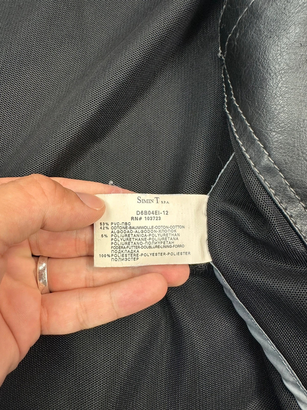Armani Jeans black faux leather jacket with worn pockets and minimalist design.