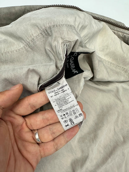 Dolce & Gabbana beige grey bomber jacket with faded nylon and logo details.