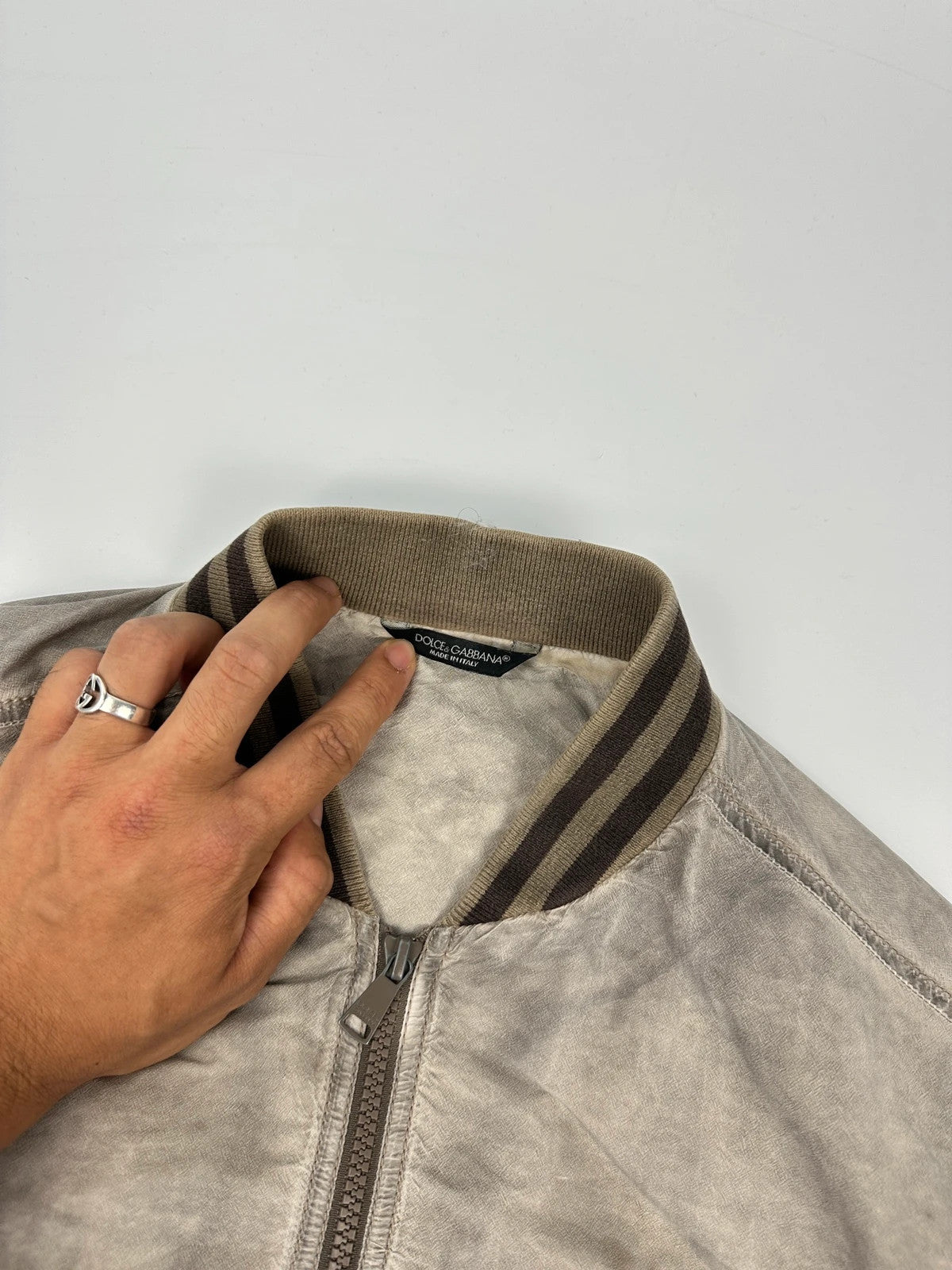 Dolce & Gabbana beige grey bomber jacket with faded nylon and logo details.