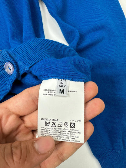 Maison Margiela electric blue cardigan with shoulder holes, minimalist design, soft knit material.