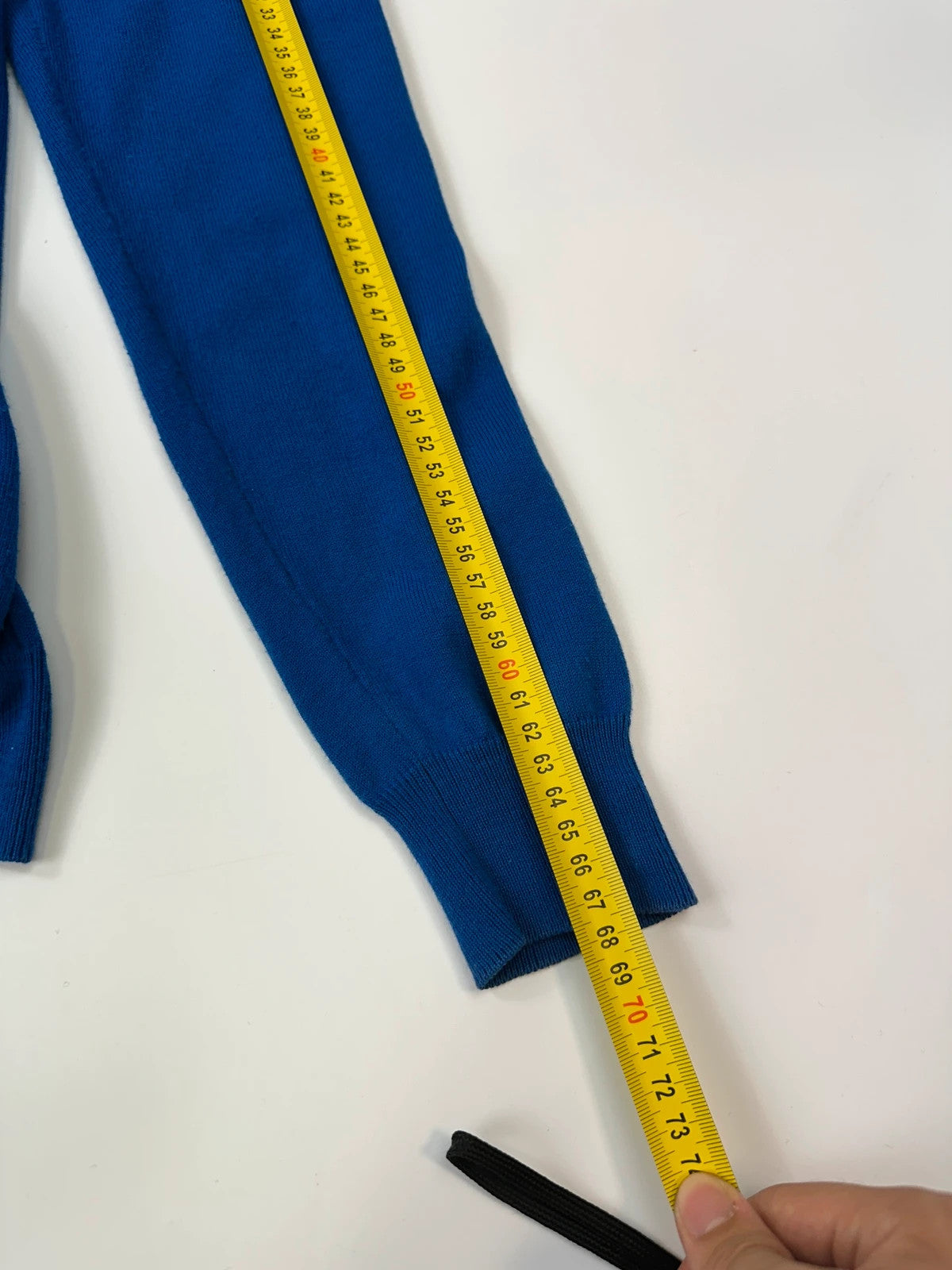 Maison Margiela electric blue cardigan with shoulder holes, minimalist design, soft knit material.