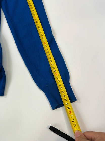 Maison Margiela electric blue cardigan with shoulder holes, minimalist design, soft knit material.