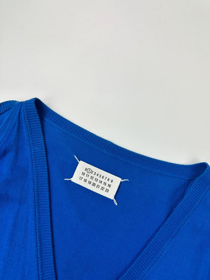 Maison Margiela electric blue cardigan with shoulder holes, minimalist design, soft knit material.