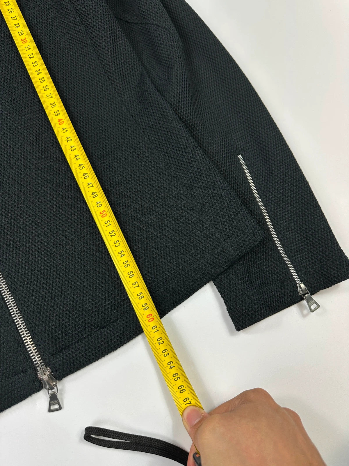Prada black mesh and leather jacket with logo detailing and vintage design elements.