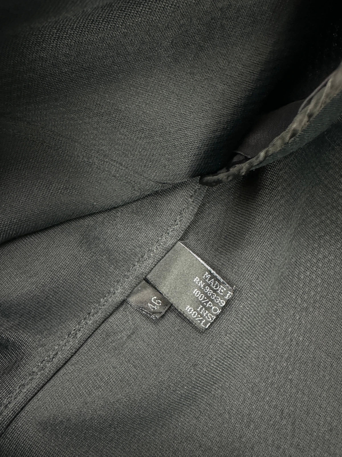 Prada black mesh and leather jacket with logo detailing and vintage design elements.