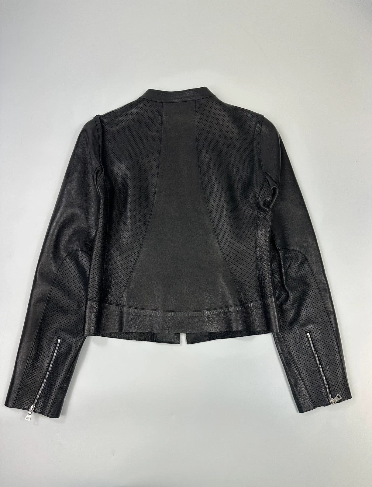 Prada black perforated leather jacket with subtle logo detailing and minimalist design.
