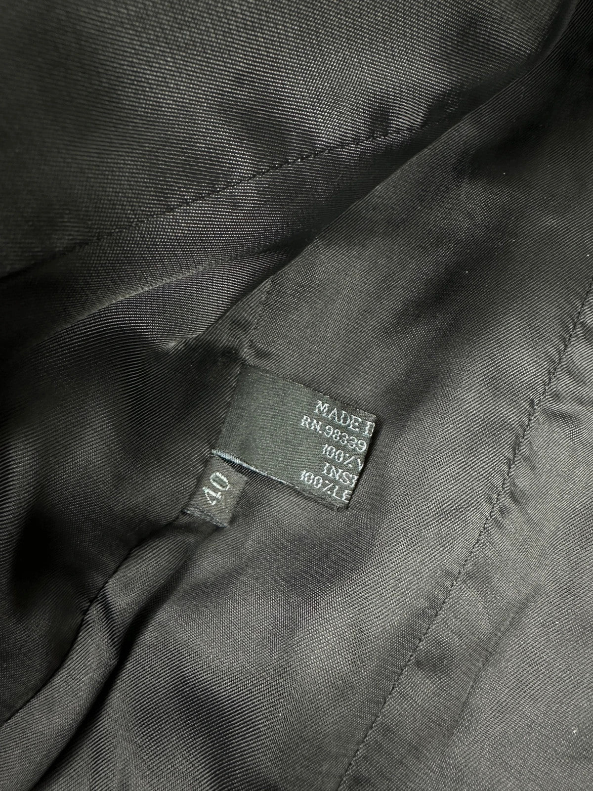 Prada black wool and leather jacket with biker-style detailing and logo accents.