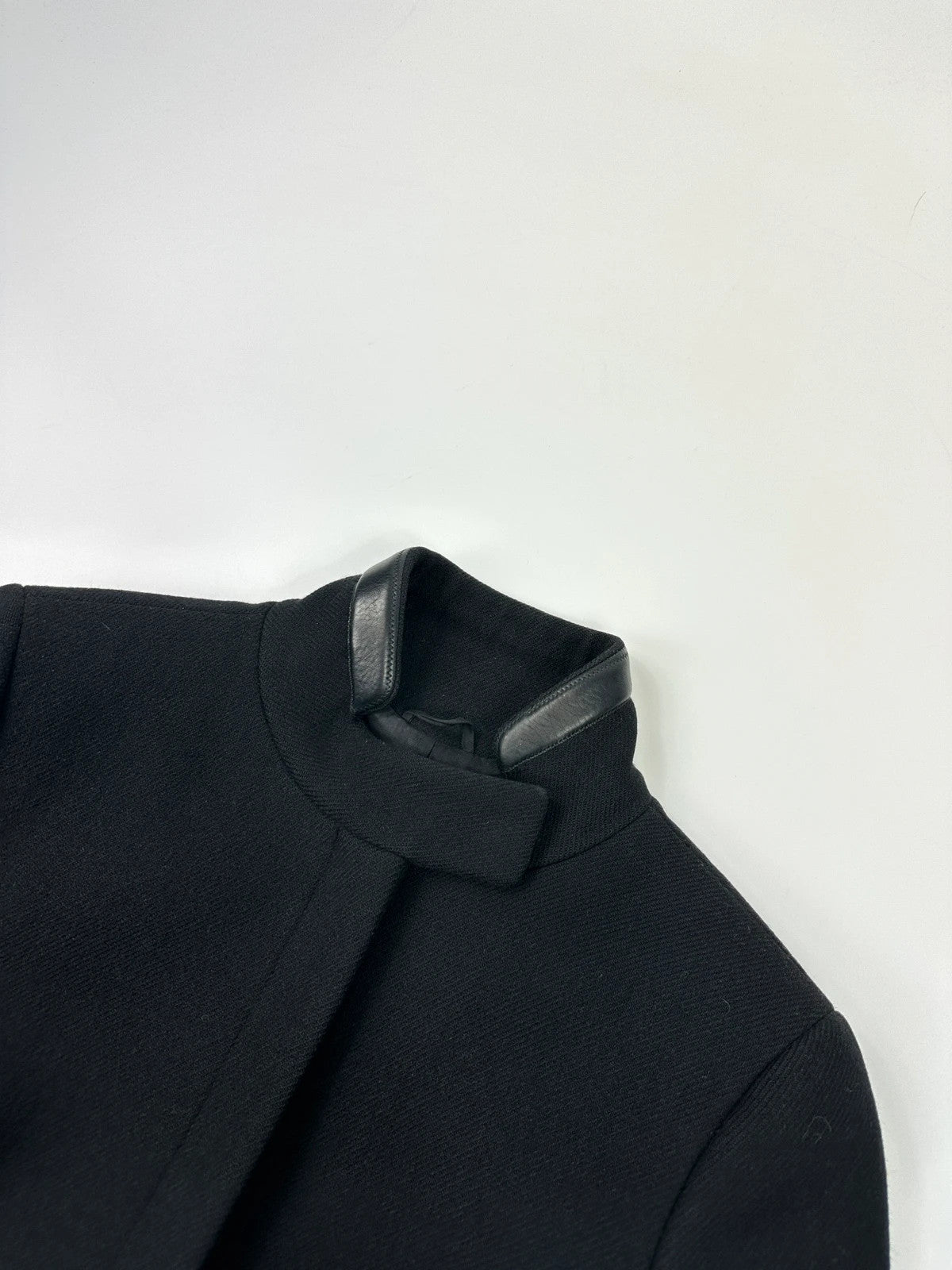 Prada black wool and leather jacket with biker-style detailing and logo accents.