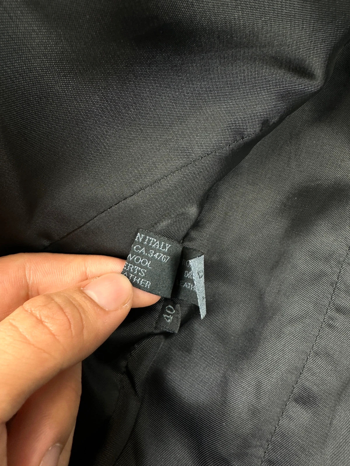 Prada black wool and leather jacket with biker-style detailing and logo accents.