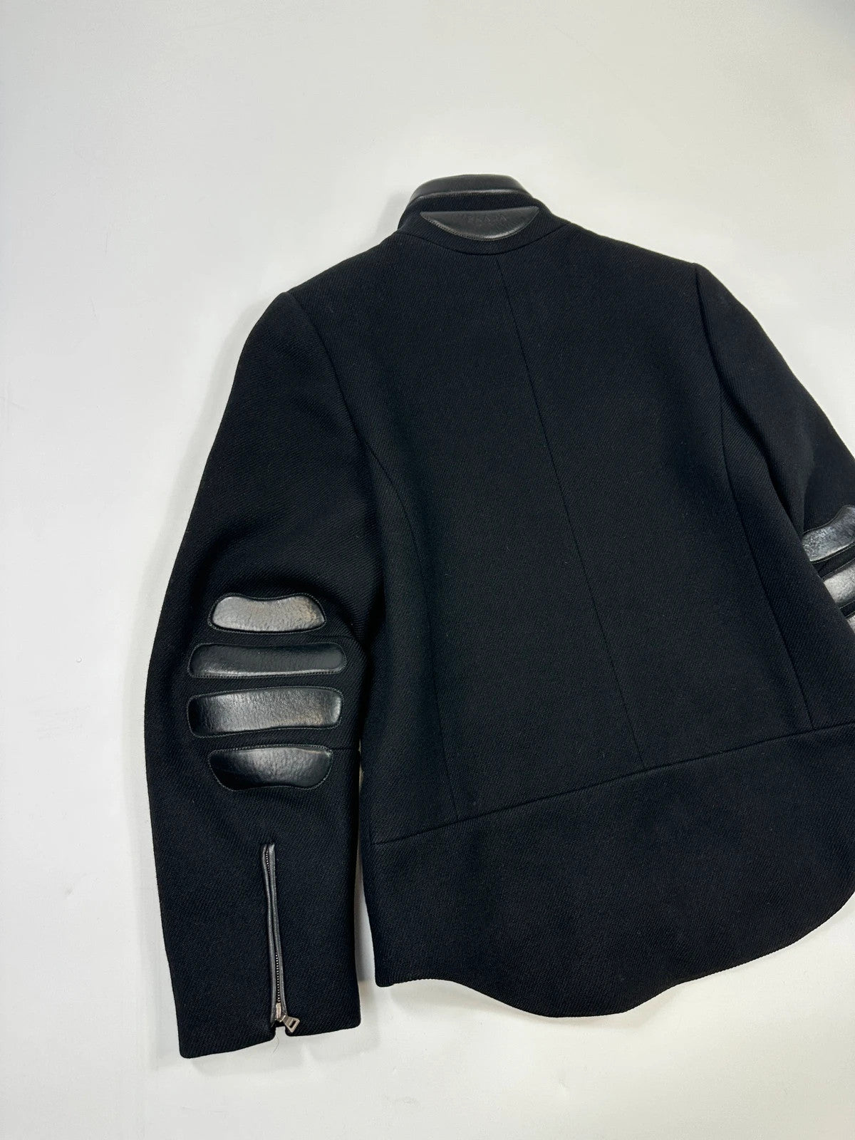Prada black wool and leather jacket with biker-style detailing and logo accents.